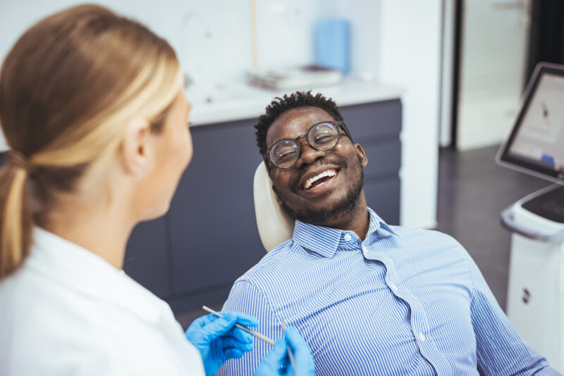 man smiling widely after dental decay treatment